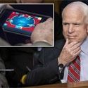 McCain plays poker on an iPad in session